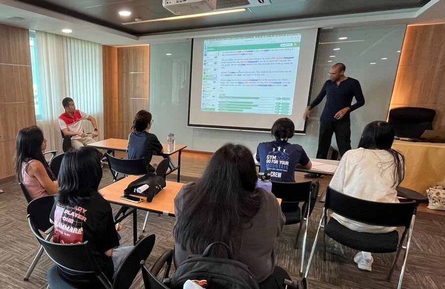 Yew Tee CC YouthThink session – Ravich and Allen presenting EssayAce.AI feedback on screen